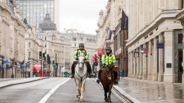 Police patrol the lockdown in Regent Street, London's shopping mecca.