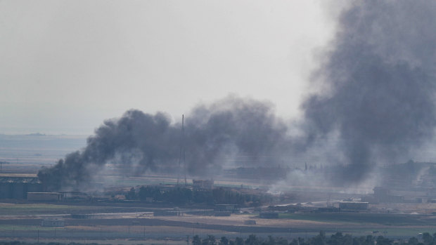 Smoke rises over the Syrian town of Ras al-Ain, as seen from the Turkish border town in Ceylanpinar, Turkey. 