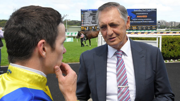 Trainer Peter Snowden speaks with jockey Tim Clark after a rise on Anaheed.