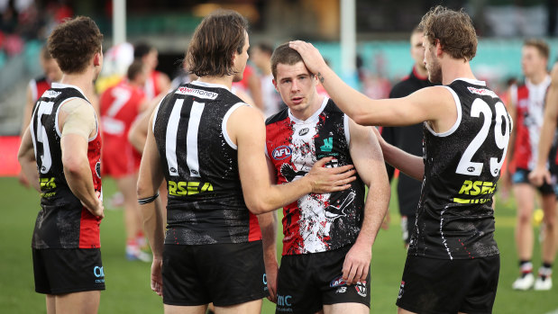 Jack Higgins is consoled by teammates after the loss to the Swans.