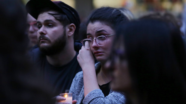 Mourners are seen during a candlelight vigil for murdered Sydney dentist Preethi Reddy in Sydney.