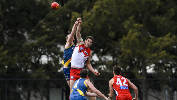 Canberra's Cameron Milne and Sydney's Darcy Cameron contest the ball.