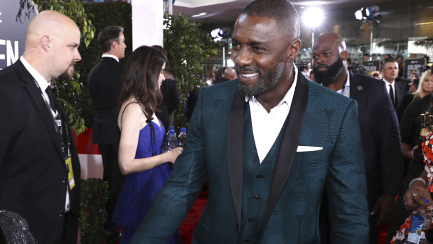 A dashing Idris Elba arrives at the Golden Globes.