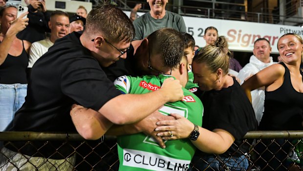 Ethan Sanders embraces his family at 4 Pines Park on Saturday night.