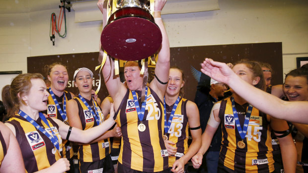 Hawthorn players celebrate after winning the VFLW grand final in 2018. 
