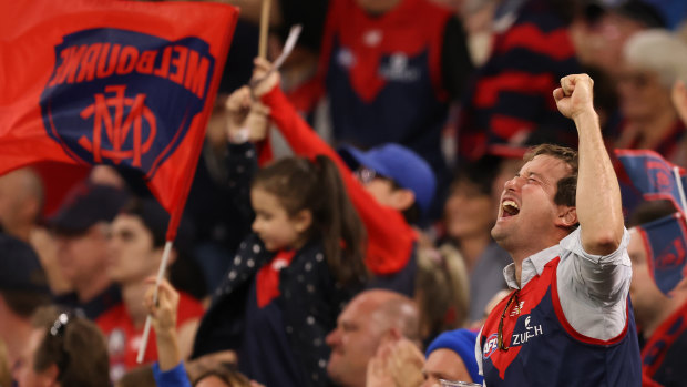 The Demons faithful in raptures at Optus Stadium.