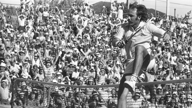 Victory leap … Newcombe jumps the net after defeating Connors.