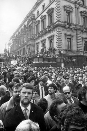 Crowds gather at the Treasury Building before marching down Bourke Street.