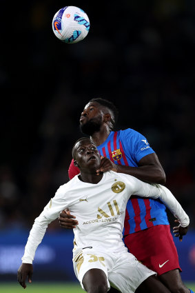 Garang Kuol competes with Samuel Umtiti for an aerial ball.