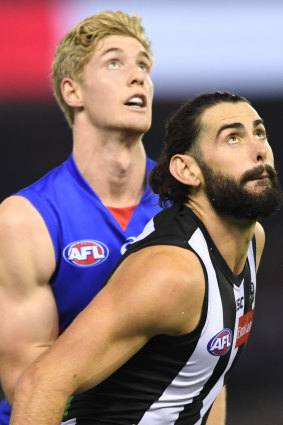 A tall story: Bulldog Tim English and Magpie Brodie Grundy.