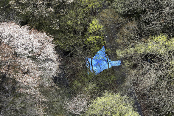 A plastic sheet covers the site where the dead bodies of an older couple were found in Nasu town, Tochigi prefecture, north-east of Tokyo, this year.