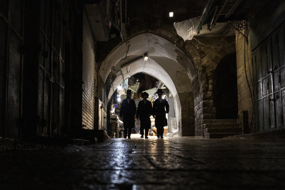 Ultra-Orthodox Jewish men walk in the Old City in Jerusalem. 