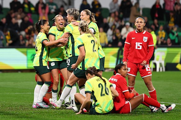 Players mob Charli Grant after her winner at the death.