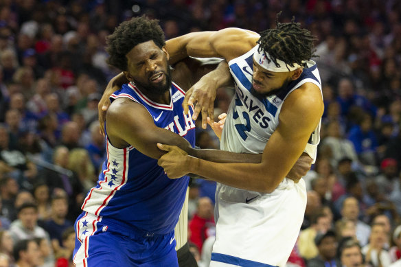 The 76ers' Joel Embiid (left) and Timberwolves' Karl-Anthony Towns come to grips with each other.