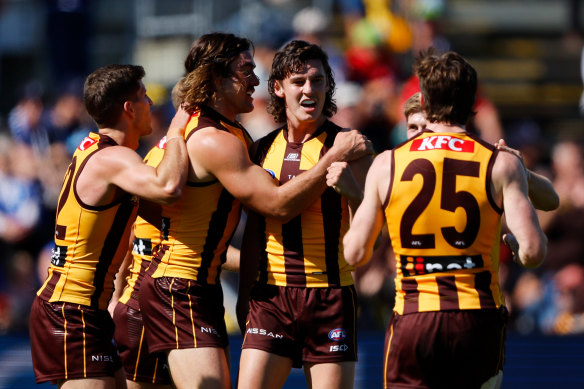 Connor Macdonald, centre, celebrates a goal in round three. 