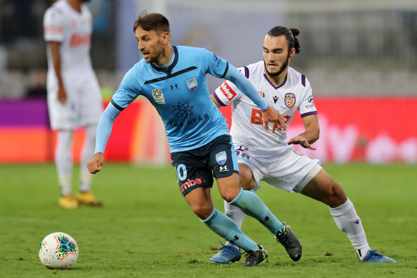 Milos Ninkovic skips away from Nick D'Agostino in Sydney's 0-0 draw with Perth Glory on Saturday - one of the last A-League games that will be open to the public this season.