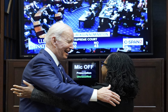 President Joe Biden congratulates Judge Ketanji Brown Jackson as they watch the Senate vote on her confirmation on Thursday.