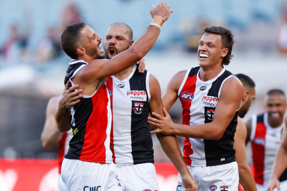 Ben Long, Paddy Ryder and Marcus Windhager celebrate one of the Saints’ many goals on Sunday.