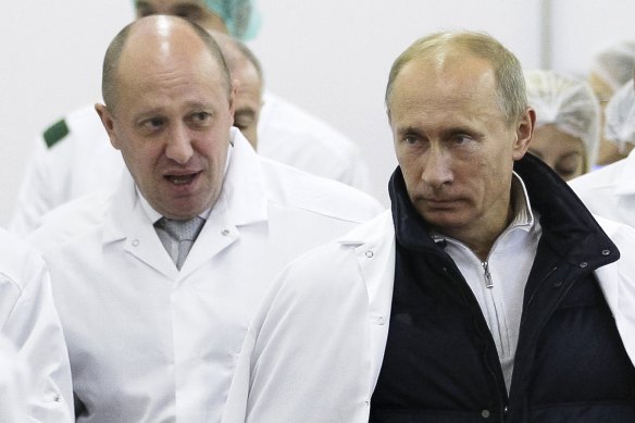 “Putin’s chef” Yevgeny Prigozhin, left, shows Russian President Vladimir Putin around his factory in 2010.
