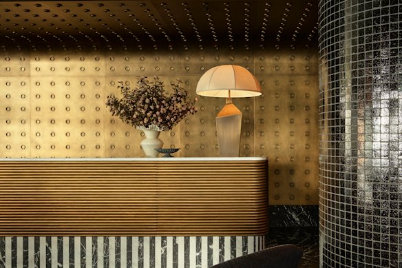 The reception desk’s 1980s-inspired monochromatic piano key motif.