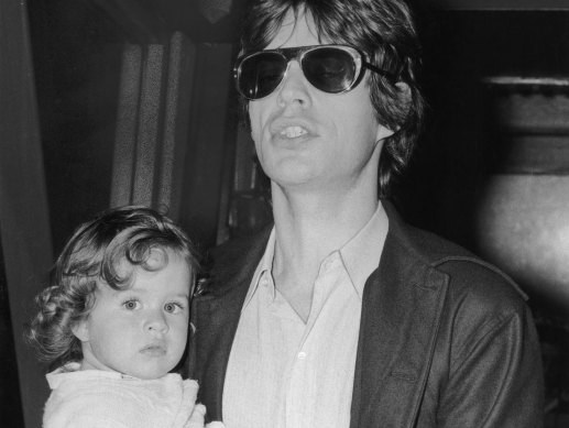 Rolling Stones singer Mick Jagger with his daughter Jade, 1973.
