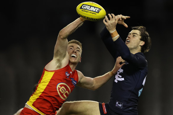 Gold Coast’s Jacob Townsend and Lachie Plowman of the Blues fly for the ball.