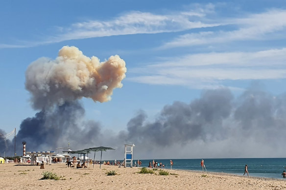 Rising smoke can be seen from the beach at Saky after explosions were heard from the direction of a Russian military airbase near Novofedorivka, Crimea.