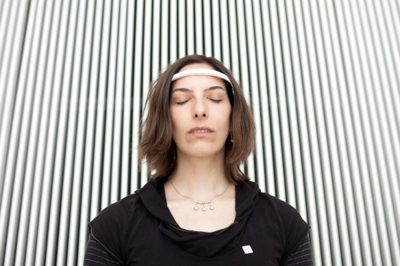 Natasha Schull, a cultural anthropologist and associate professor at MIT, demonstrates “Muse: the brain sensing headband” in Cambridge, Massachusetts in 2015.