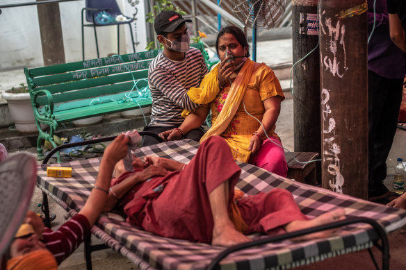 Patients suffering from COVID-19 are treated with free oxygen at a makeshift clinic in India. 