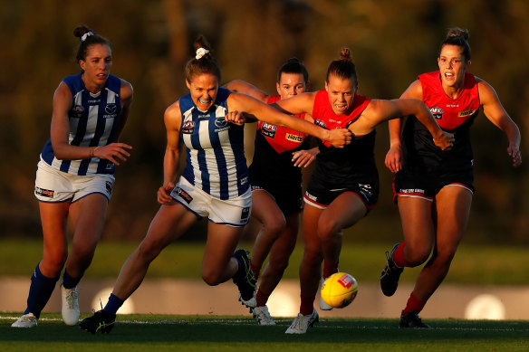 Maddison Gay of the Demons and Emma Kearney of the Kangaroos battle for possession on Saturday.