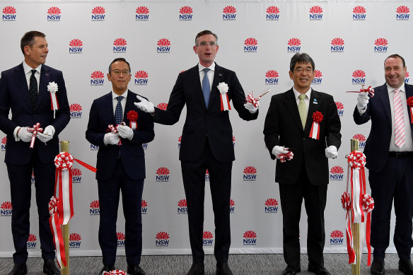 The premier donned white gloves to cut the ribbon on the new Investment NSW office.