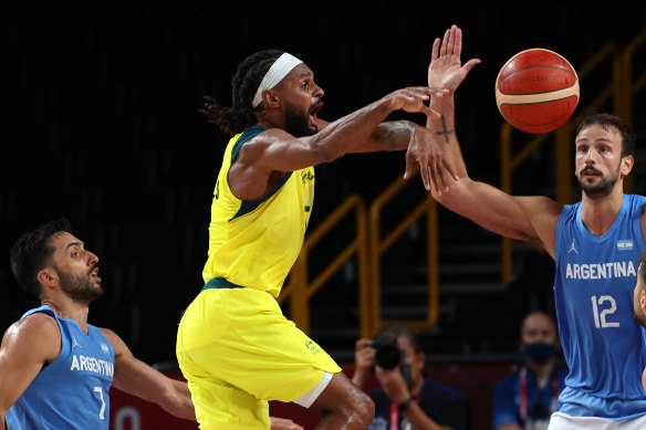 Australia’s star player Patty Mills passes the ball.