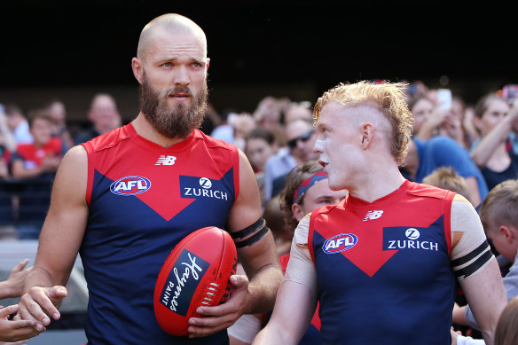 Melbourne captain Max Gawn with Clayton Oliver.