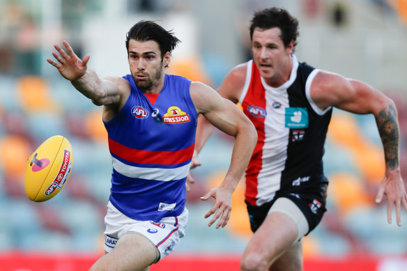 Jake Carlisle, of the Saints, chases down Easton Wood, of the Bulldogs, in the second elimination final.