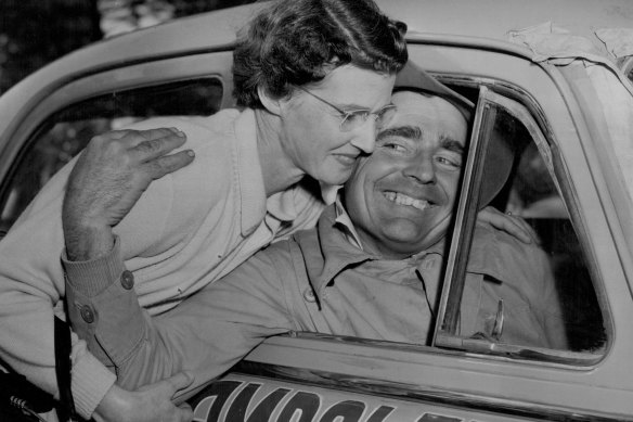 Ampol trial winner Wilf Murrell (Peugot No 32) is greeted by his wife on arrival at Bondi, July 29, 1956.