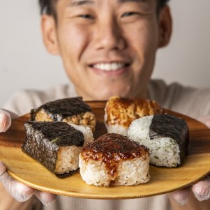 A plate of onigiri held by Comeco Foods co-owner Masa Haga.