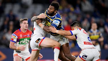 Barnstorming: Sivo is tackled by Mitchell Pearce and Mason Lino of the Knights.