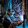 Worker Isra Nand carries out welding repairs to a bendy bus at a maintenance facility at Smithfield in Sydney’s west.