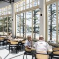 The dining room has expansive views of the Pacific Ocean and Norfolk pines.