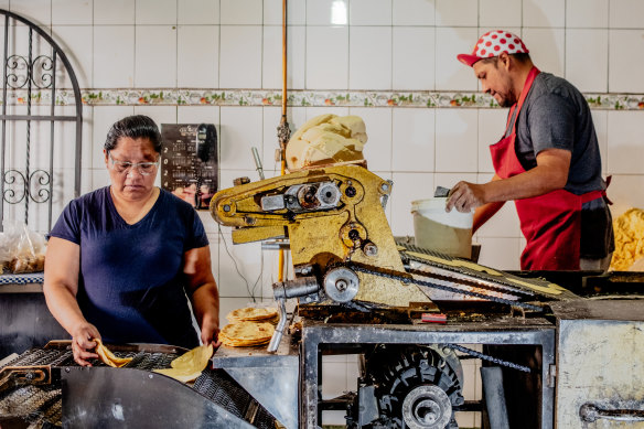 Erika Flores and Luis Flores make tortillas in Mexico City.