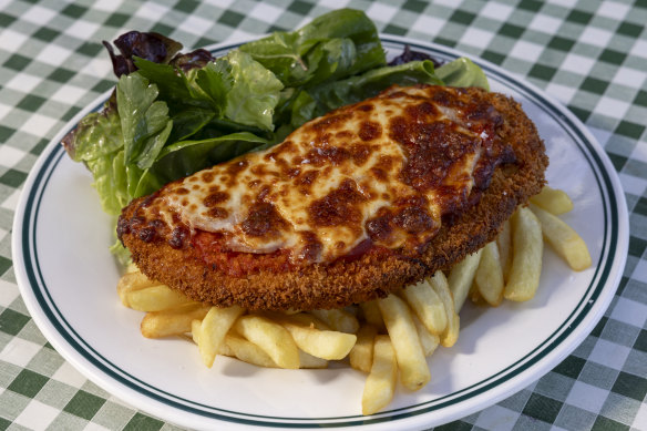 Chicken parma, ham, Napoli sauce, cheese, chips and local leaves.   