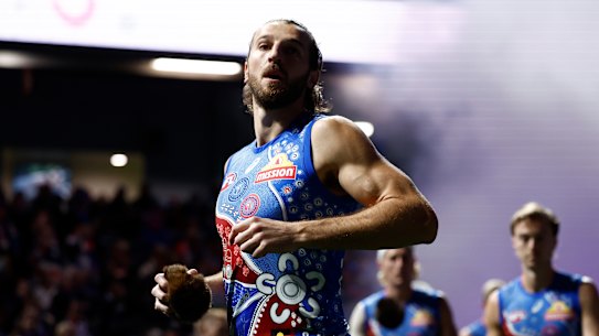 Marcus Bontempelli of the Bulldogs is seen with a possum skin ball pre-game.