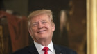 US President Donald Trump smiles at a White House event shortly after the release of the redacted Mueller report. 