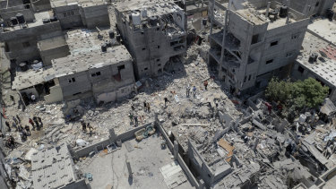 Palestinians search through the rubble of a building in Rafah, southern Gaza Strip where Khaled Mansour, a top Islamic Jihad militant, was killed in an Israeli airstrike.