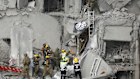 Emergency responders work at a building where at least four people died in a missile strike on June 24, 2025 in Beersheba, Israel. 