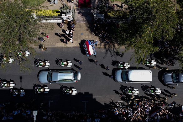 Honor guards carry the flag-draped coffin of former Chilean President Sebastian Pinera to the Congress building in Santiago, Chile.
