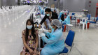 A health worker administers a dose of the Sinovac Biotech COVID-19 vaccine at the Bang Sue Grand Station in Bangkok.