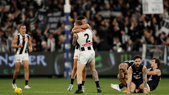 MELBOURNE, AUSTRALIA - AUGUST 21: Nick Daicos of the Magpies and Jordan De Goey of the Magpies celebrate after the final siren during the 2022 AFL Round 23 match between the Carlton Blues and the Collingwood Magpies at the Melbourne Cricket Ground on August 21, 2022 in Melbourne, Australia. (Photo by Dylan Burns/AFL Photos via Getty Images)
