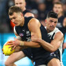 Carlton skipper Patrick Cripps is wrapped in a tackle by Collingwood’s Scott Pendlebury.