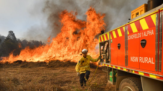 NSW RFS firefighters battle the bushfire on Long Gully Road at Drake on Monday. 